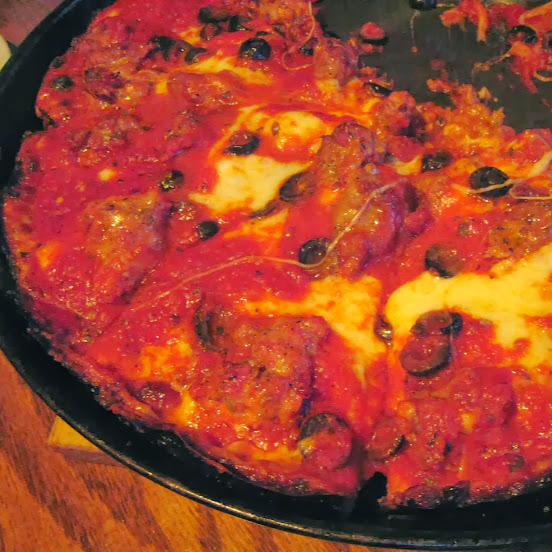 Pequod's deep-dish pizza with sausage and black olive