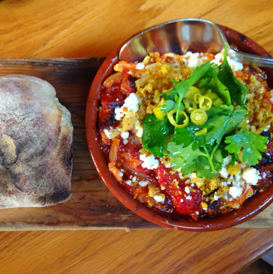 Baked egg with roasted peppers, chickpeas, guanciale, feta, and breadcrumbs