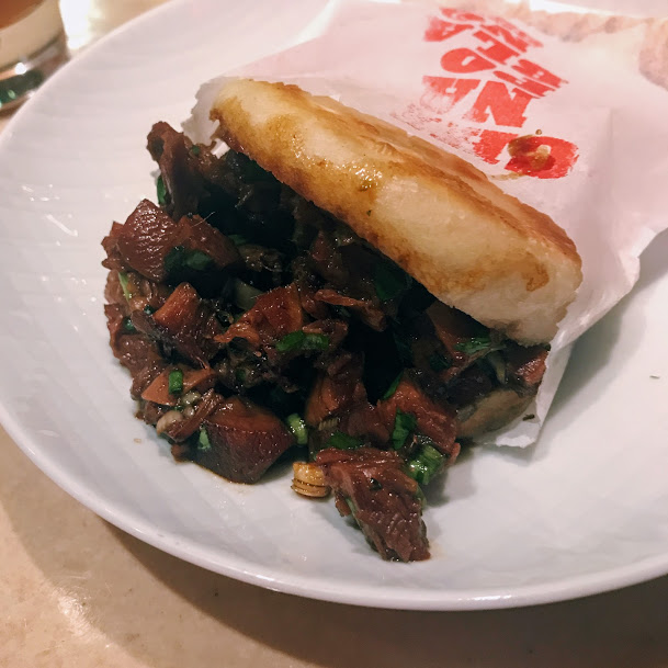 Rou Jia Mo street sandwich with red-braised pork belly, cilantro, and scallion, China Poblano