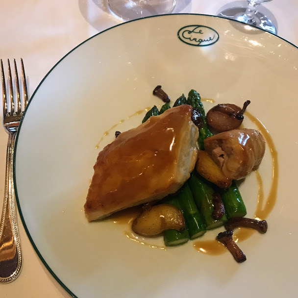 Le poulet rôti with roasted organic chicken, asparagus, hedgehog mushrooms, roasted baby potatoes, and foie gras sauce