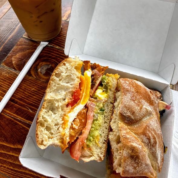 Veg Out sandwich with house-baked ciabatta, guacamole, feta cheese, tomatoes, roasted sweet potato, pickled onions, Blue Horse sandwich sauce, farm fresh egg, Wisconsin cheddar cheese, and roasted red peppers, Blue Horse Beach Cafe