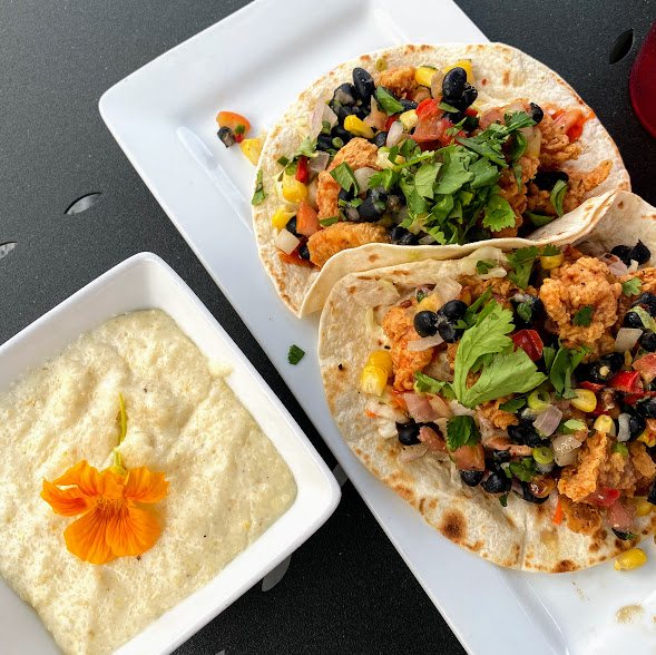 Alligator tacos with cajun fried gator, lemongrass slaw, chili sauce, roasted corn & black bean relish, and a side of goat cheese grits, The Fireside