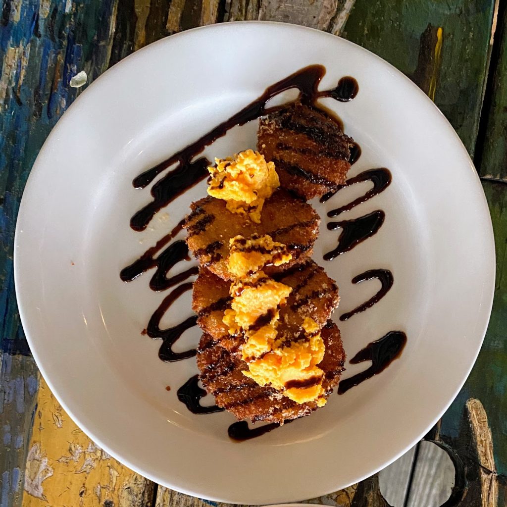 Fried green tomatoes with crispy green tomatoes, pimiento cheese, and balsamic glaze